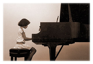 April at the piano during one of her recitals, circa 1983