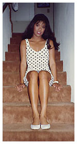 17-year-old April sitting on the steps inside the family's 3-story townhome in Spring Valley, California.